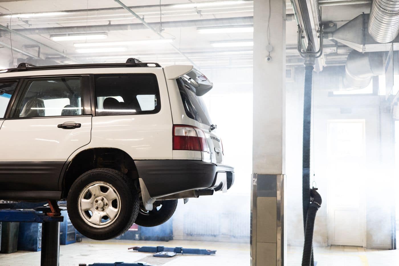 A vehicle up on the hoist in the Williams workshop